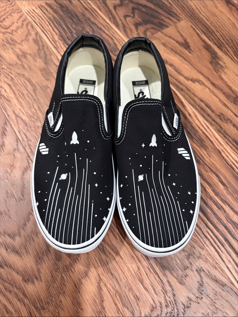 Vans Black Slip-On Sneakers with White Space Rocket Print